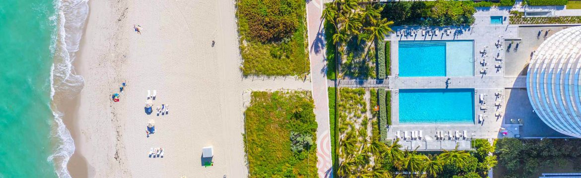 Areial of hotel pool and beachfront for the About Us Top Header Picture